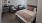 large bedroom with mini fridge and sitting area