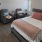 large bedroom with mini fridge and sitting area